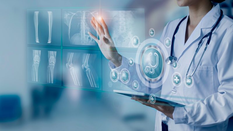 Medicine,Doctor,Hand,Touching,On,A,Patients,X-ray,Scans,Digital